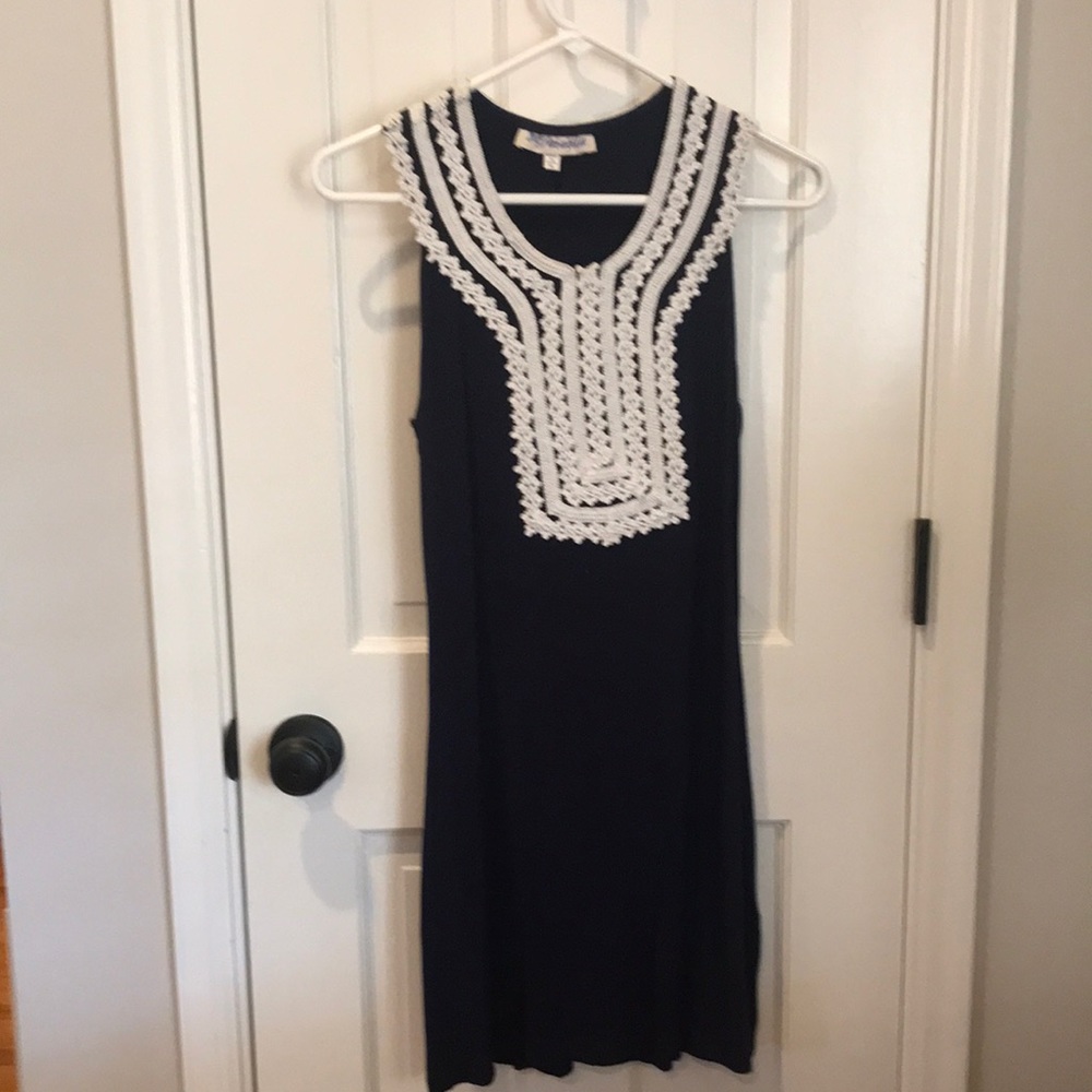 Navy, sleeveless dress with white lace detail.